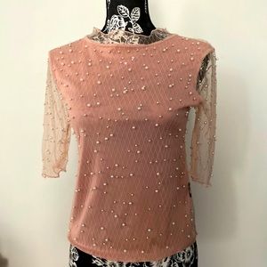 Mock neck top detailed with pearls.